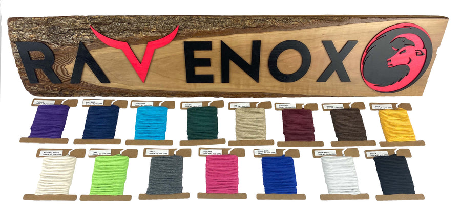 Array of Ravenox Cotton Macrame Cords in 2mm & 3mm sizes, showcased in an array of colors on cardboard disks, set against a custom wooden Ravenox sign. (8357472567533)