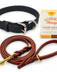 One black leather dog collar and one burgundy 1/2-inch by 6-foot leash, plus one Leather Honey box containing 5 cleaning and 5 conditioning wipes. Representative Large collar pictured; collar width and hardware details vary by selected size.