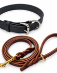 One black leather dog collar and one burgundy 1/2-inch by 6-foot leash. Representative Large collar pictured; collar width and hardware details vary by selected size.