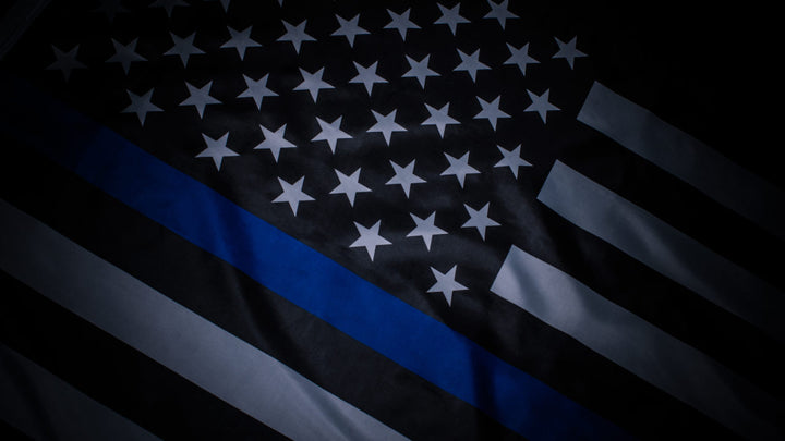 Thin Blue Line flag displayed on Ravenox website, a black and white American flag with a single blue stripe, symbolizing solidarity and tribute to law enforcement officers.