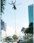 A helicopter, using Ravenox Synthetic Helicopter Longlines, hoists a jacuzzi onto the rooftop of a high-rise condominium in Hawaii. The longlines, made from ultra-strong and lightweight HMPE fiber, demonstrate their low-stretch and high-strength capabilities in this demanding lifting operation. The scene captures the practical use of these longlines, highlighting their durability and safety features essential for heavy-lift helicopter operations. (7552156795117)