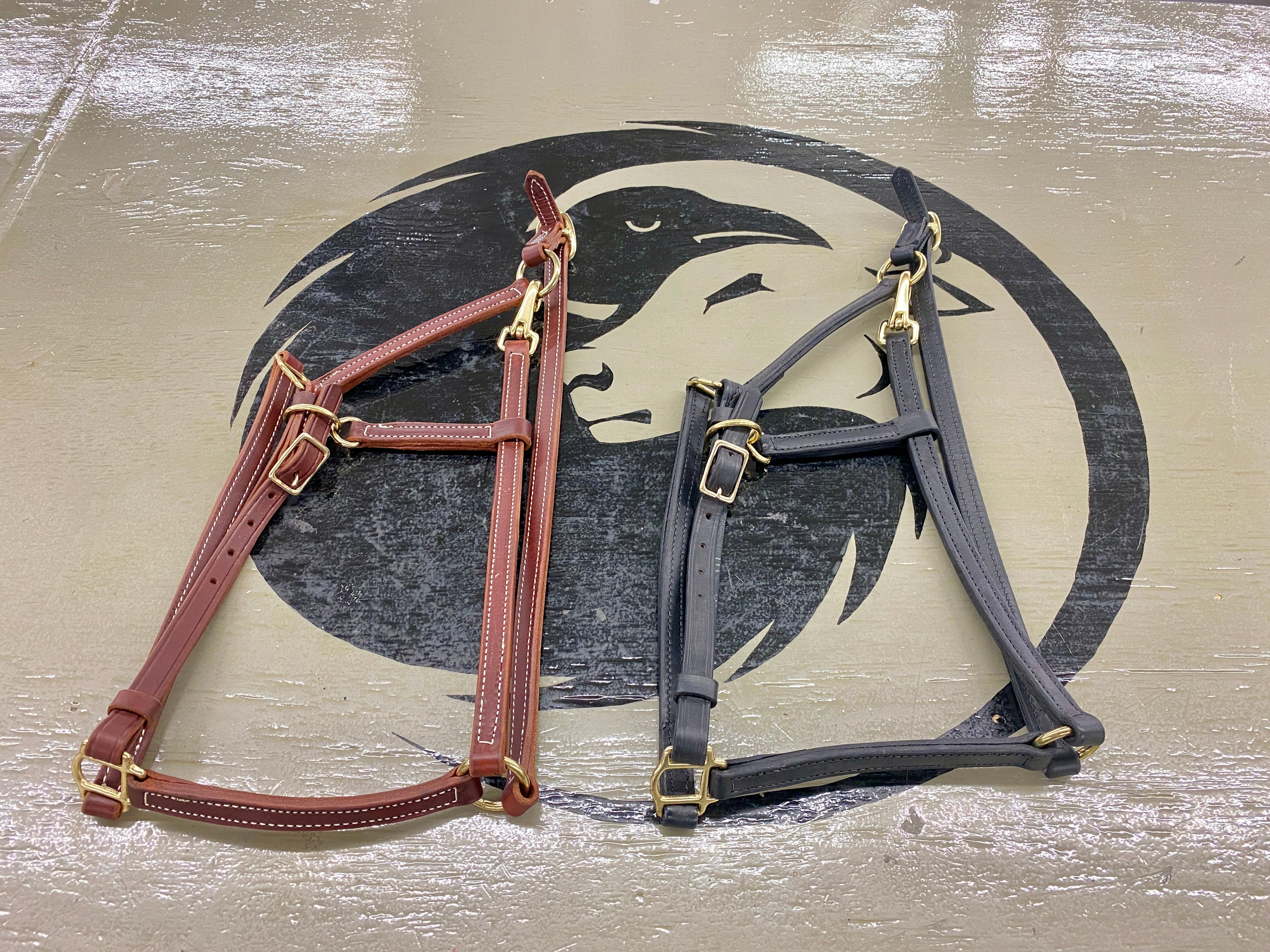 Ravenox Leather Breakaway Horse Halter displayed on Ravenox table, featuring both black and brown variants, emphasizing high-quality latigo leather, traditional Amish hand-stitching, and robust brass accents – epitomizing luxury equestrian style and function. (8233982951661)
