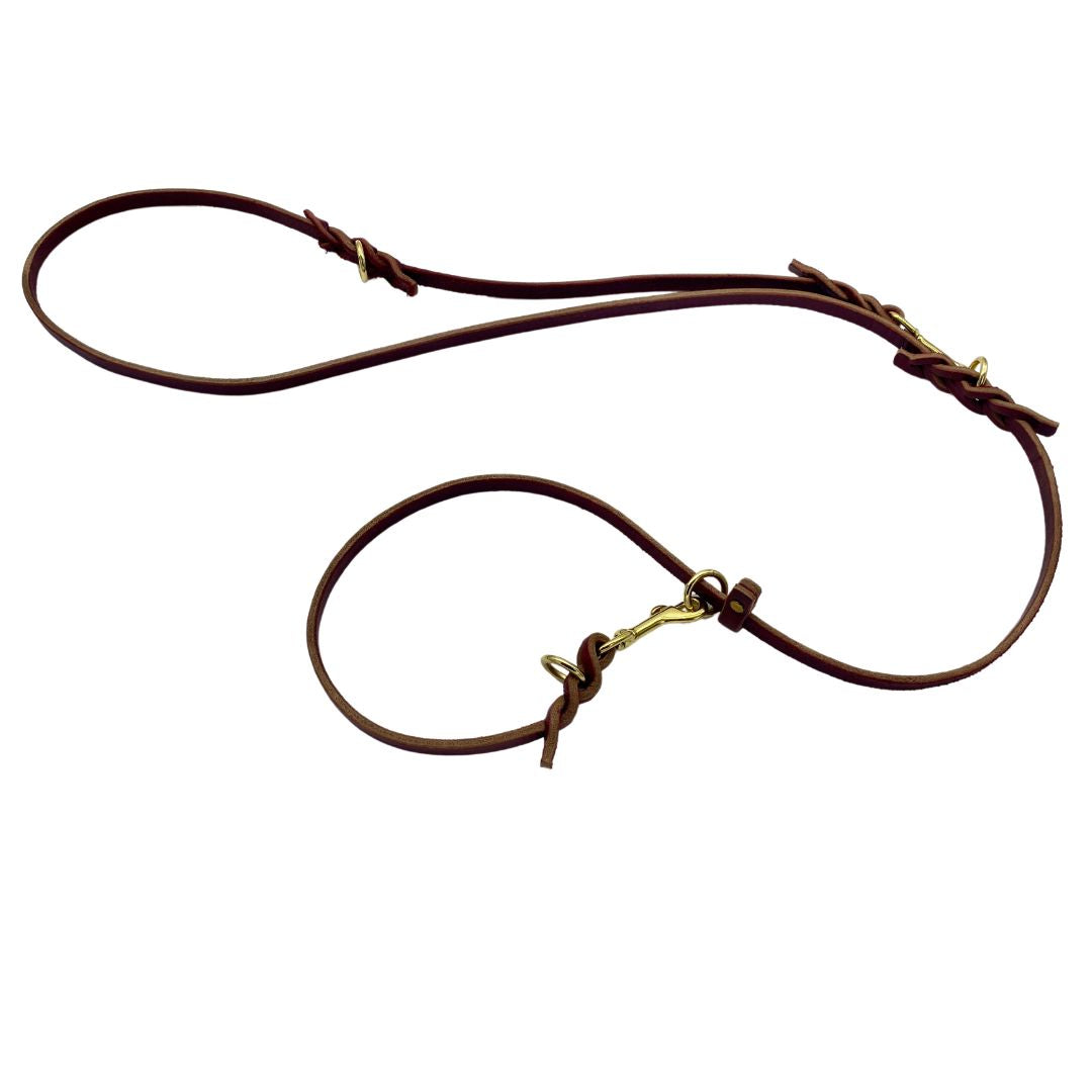 Image displaying the Burgundy and Black Ravenox Multifunctional Leather Dog Leashes, both with solid brass hardware, showcasing the superior craftsmanship of Amish methods such as hand cutting, edging, and finishing, designed for longevity and a variety of uses, from a simple walk to complex training scenarios. (7838529061101)
