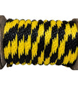 Close-up of a Ravenox black and gold/yellow solid braid polypropylene derby rope neatly coiled on a wooden spool. (8217688637677)