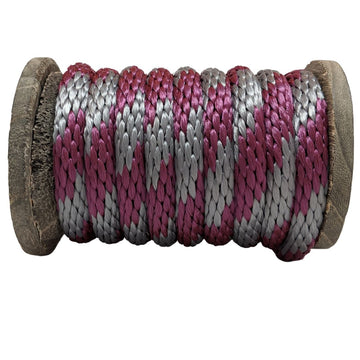Close-up of a Ravenox burgundy and silver solid braid polypropylene derby rope wound tightly on a wooden spool. (8217683558637)