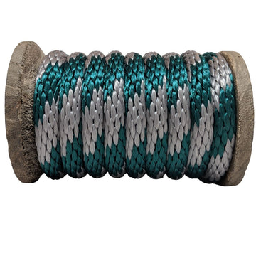 Close-up of a Ravenox hunter green and silver solid braid polypropylene derby rope coiled on a wooden spool. (8217686671597)