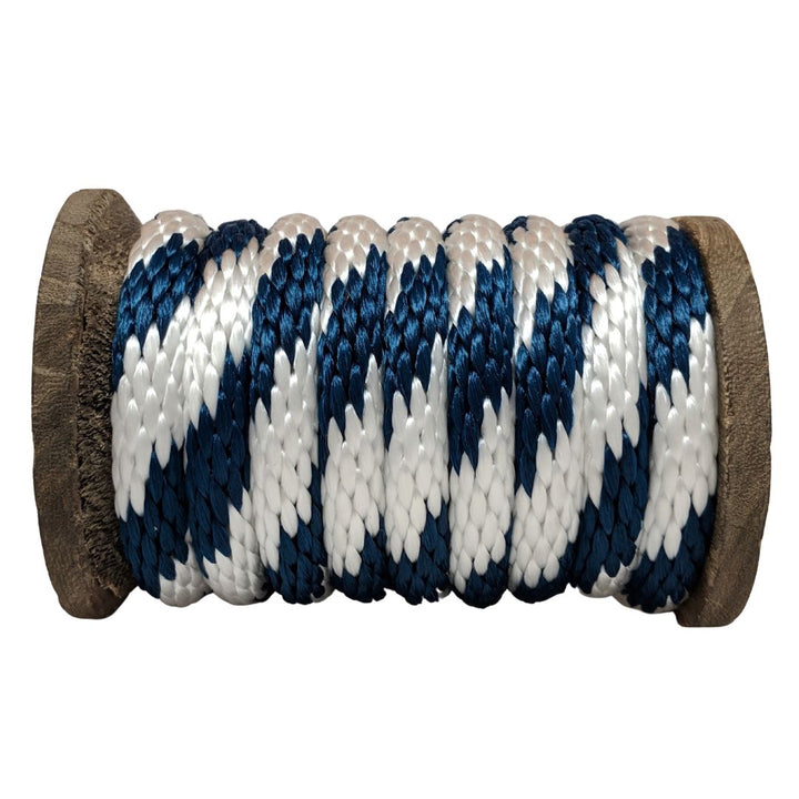 Close-up of a Ravenox navy blue and white solid braid polypropylene rope neatly wound around a wooden spool. (8217545736429)