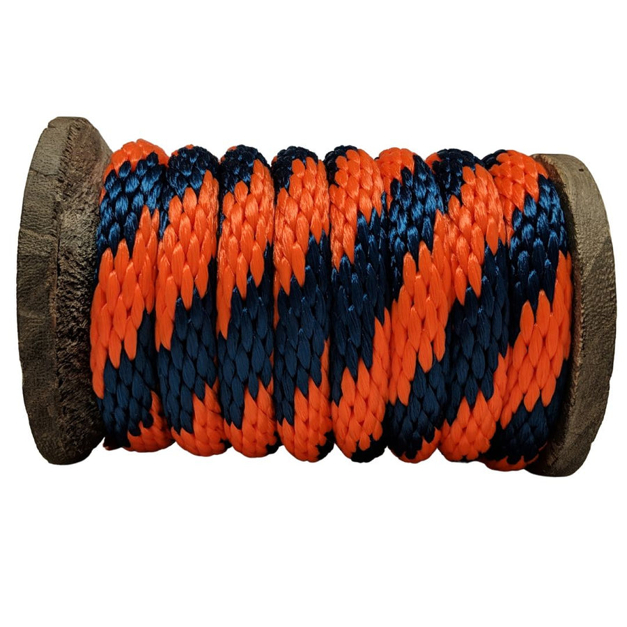 Close-up of a Ravenox orange and navy blue solid braid polypropylene derby rope coiled neatly on a wooden spool. (8217652756717)