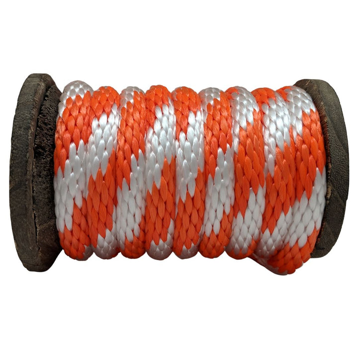 Close-up of a Ravenox orange and white solid braid polypropylene rope coiled on a wooden spool. (8217637912813)