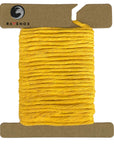 Sample image of Ravenox 2mm & 3mm Single Strand Cotton Macrame Cord in luxurious Gold color, presented on a cardboard disk, highlighting the cord's rich texture. (8357474599149)